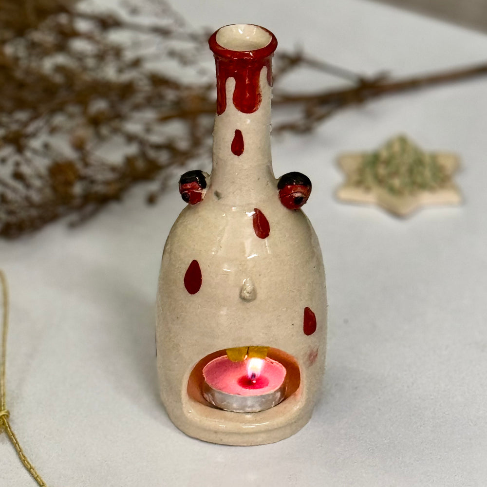 Polka Ghost Tealight, lit, close view